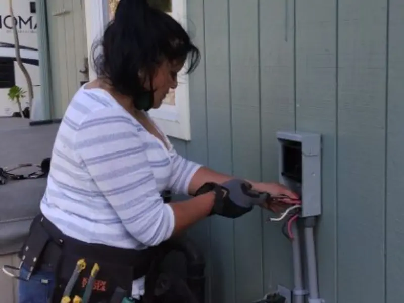 Licensed electrician wiring an exterior subpanel in Vergennes